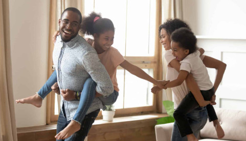 parents with back pain playing with their kids