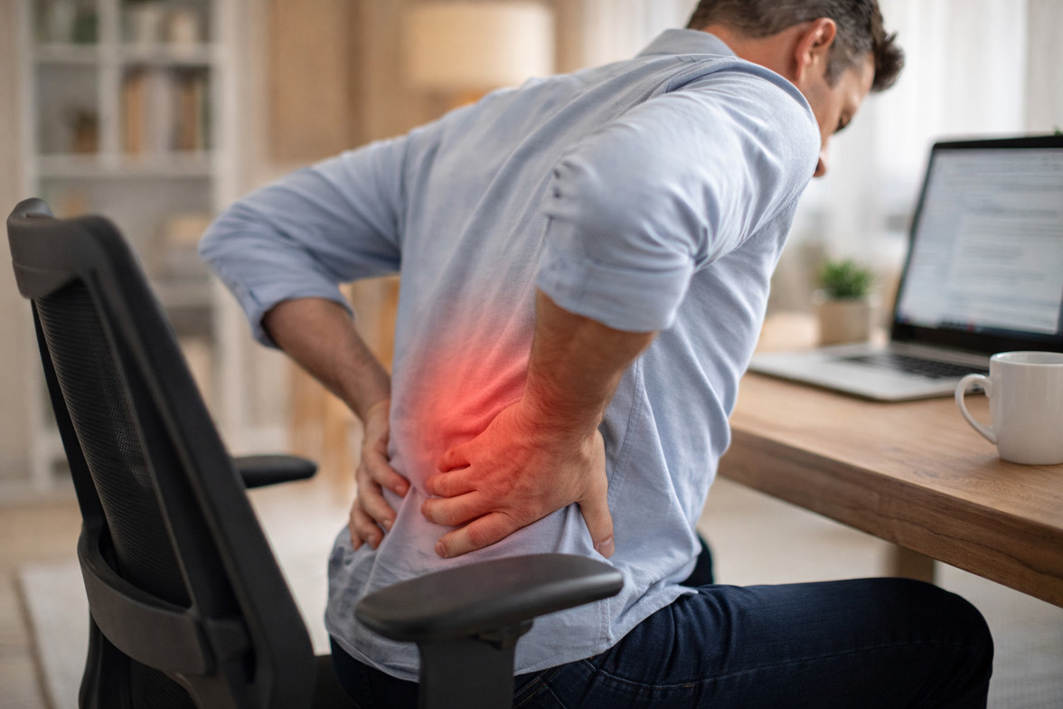 Prolonged sitting posture with subtle red highlight over the lower back