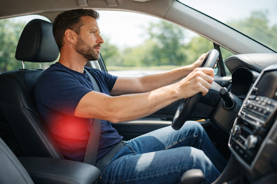 Driver sitting in car with subtle red highlight over lower back