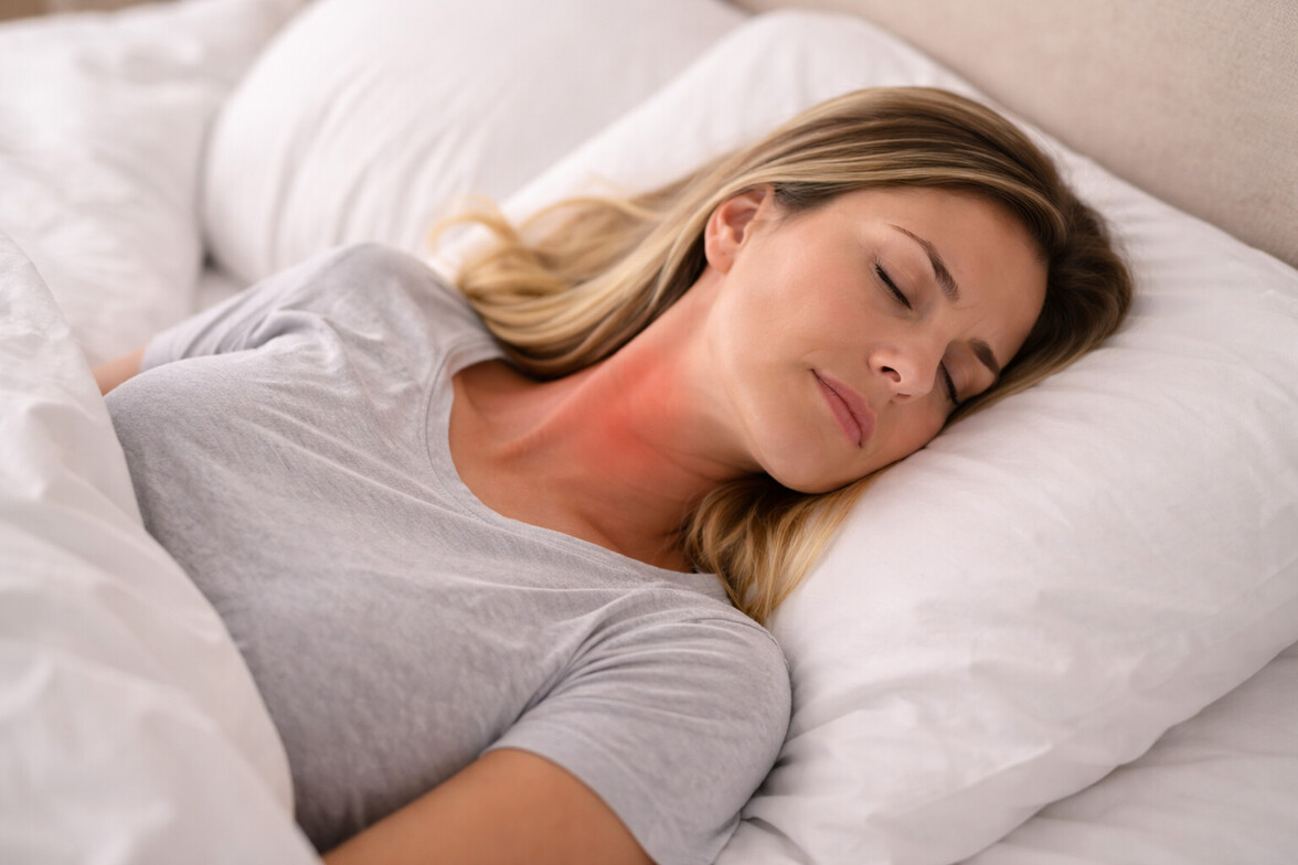 Person lying in bed with subtle red highlight on the side of the neck indicating discomfort